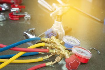 A bunch of hose and gauges are sitting on a table.