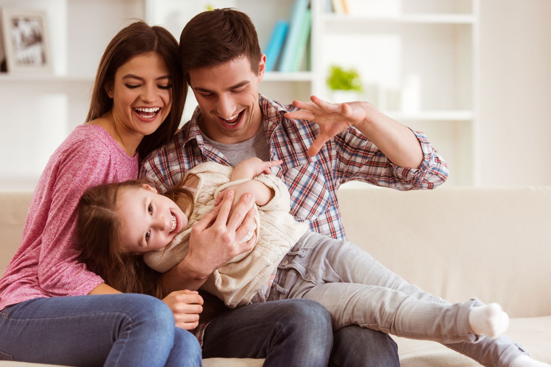Family on couch and smiling