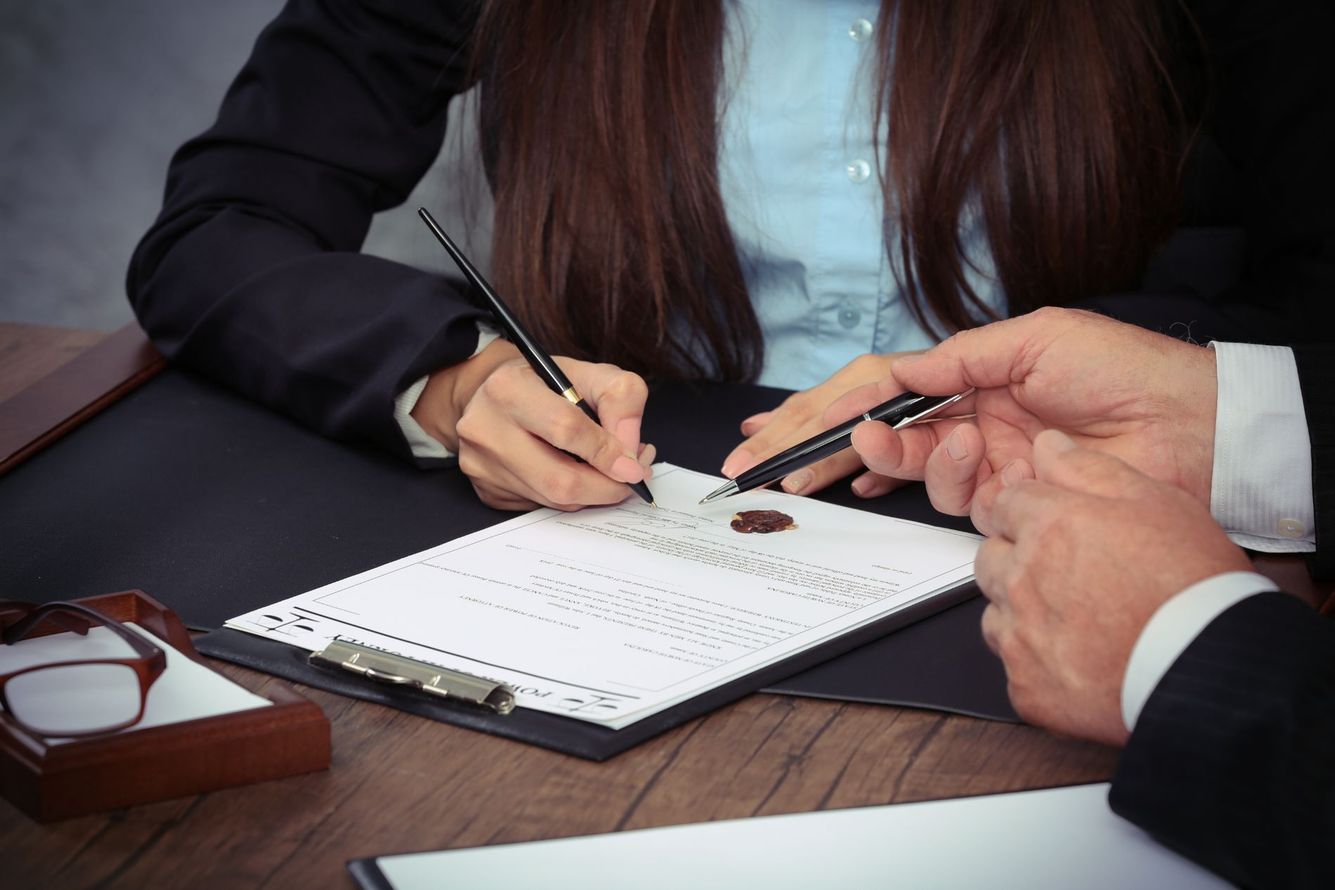 Woman signing estate planning form