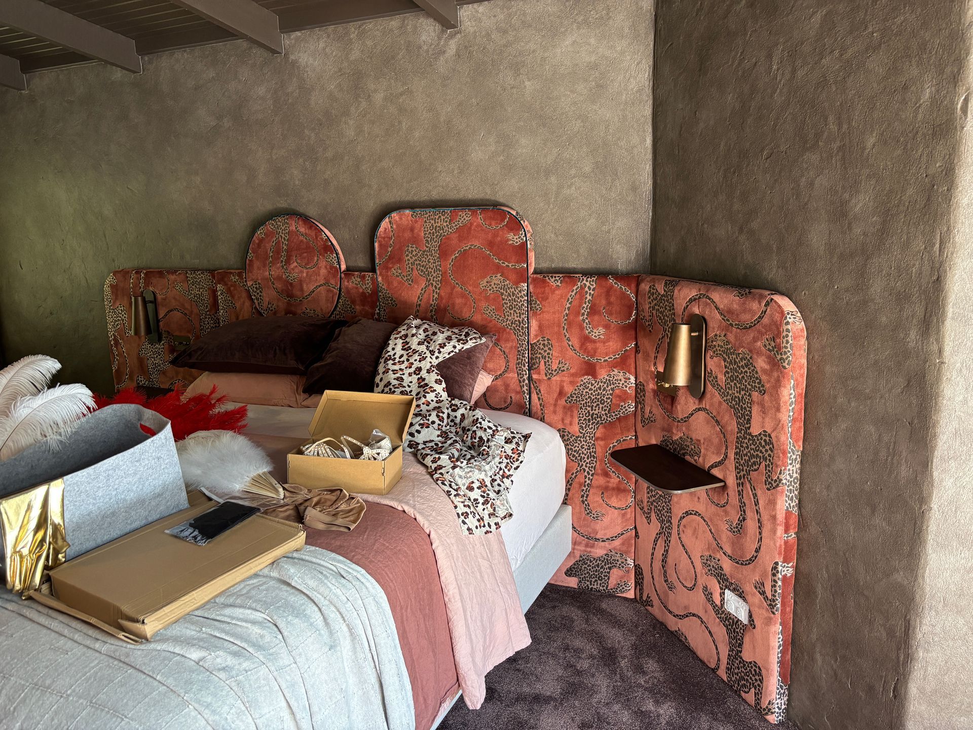 Bed head upholstered in Catherine Martin x Mokum Panthera fabric