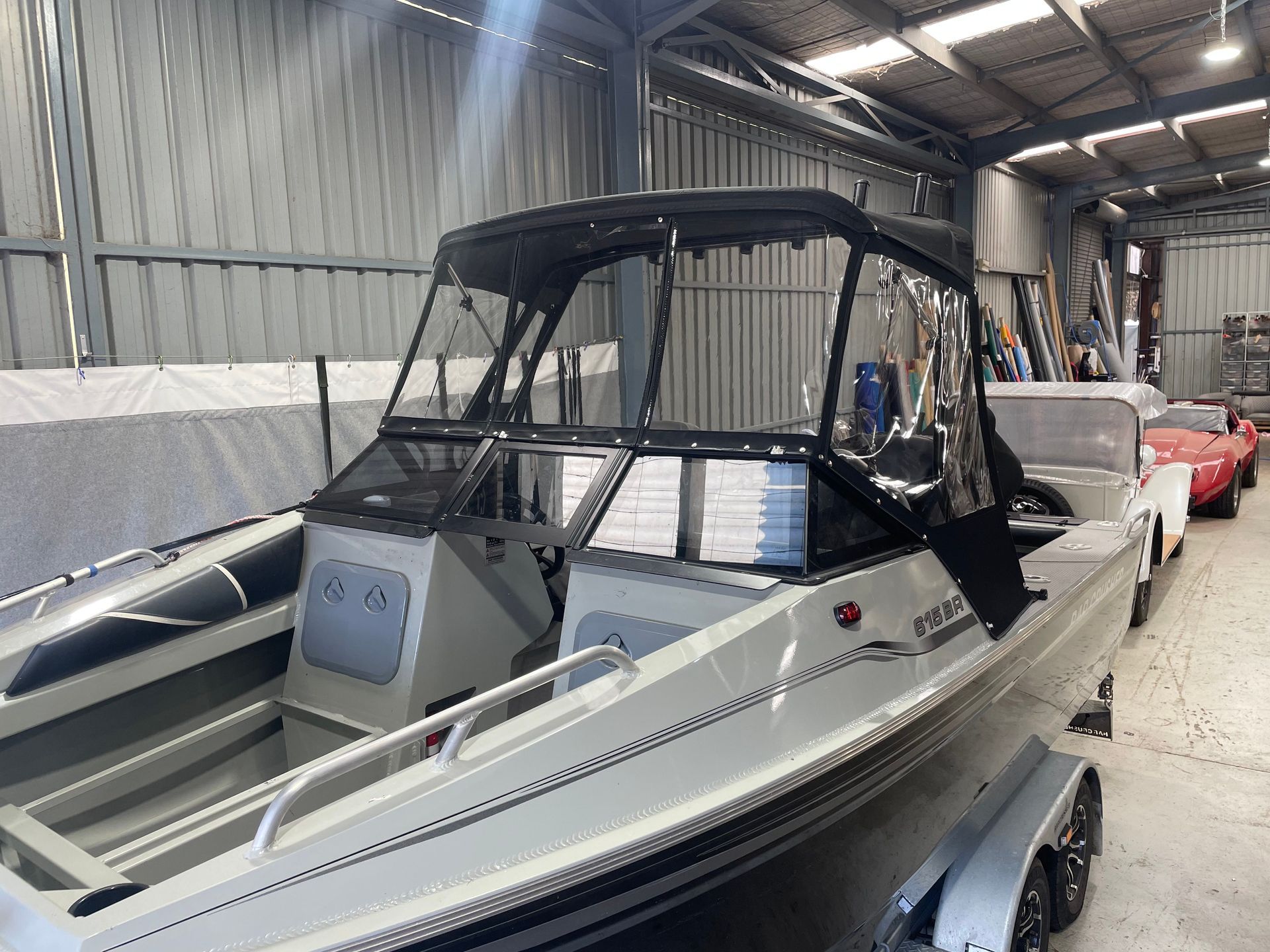 Bar Crusher 615BR bimini with clear front and side curtains