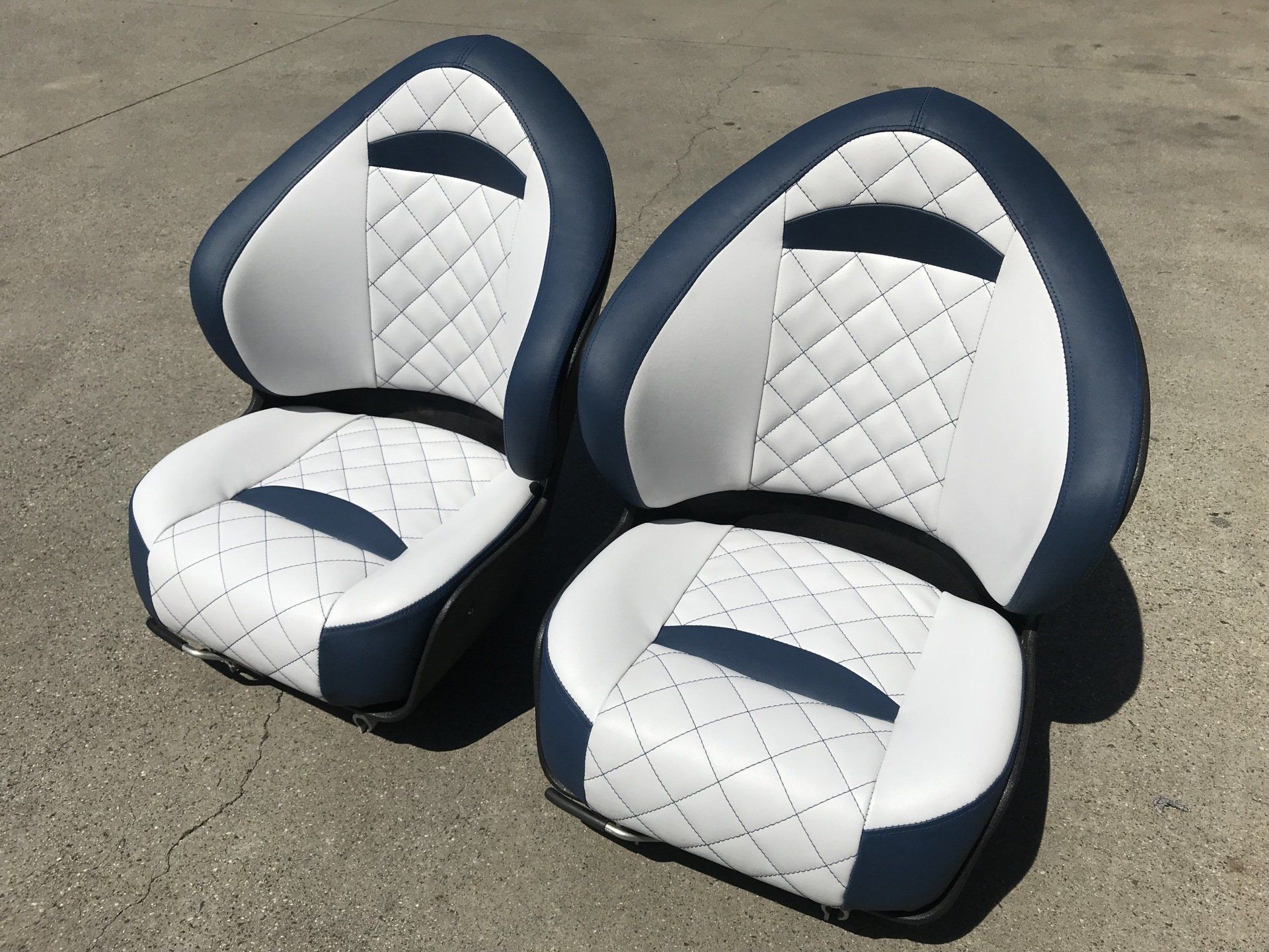 Blue and white boat seats with cross stitch inserts
