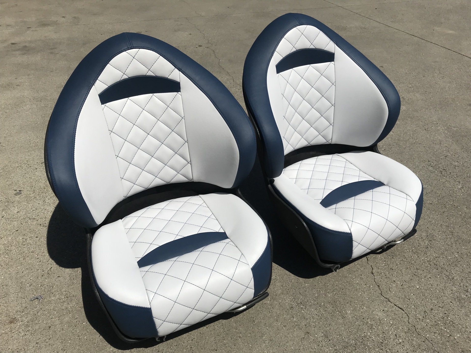 Blue and white boat seats with cross stitch inserts