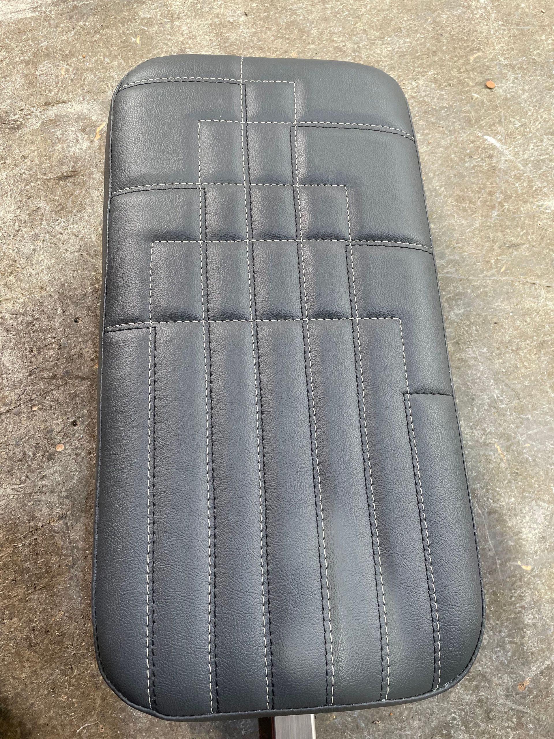 Custom designed padded cushion black vinyl stitched design