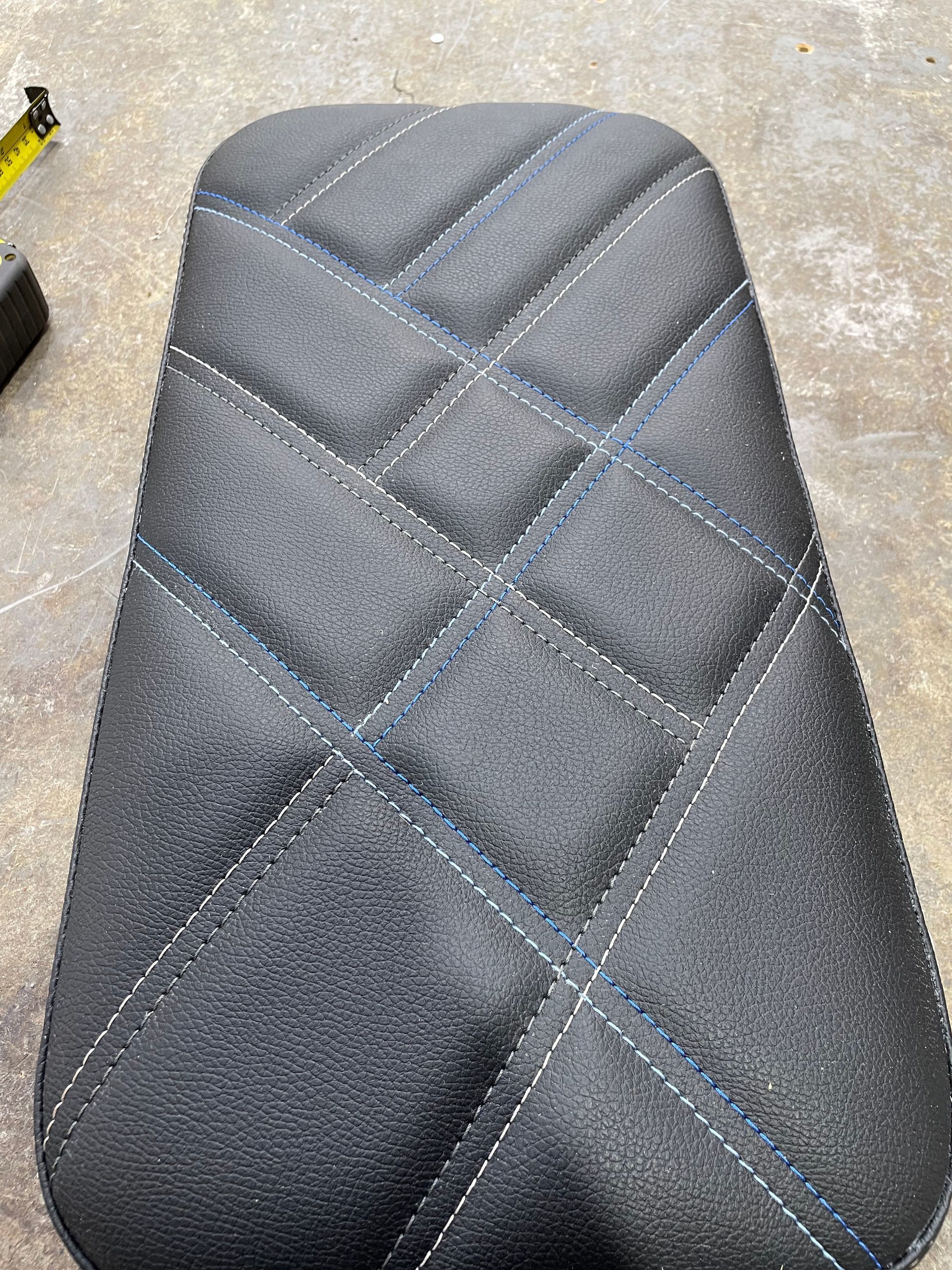 Custom designed padded cushion black vinyl with silver and blue cross stitch