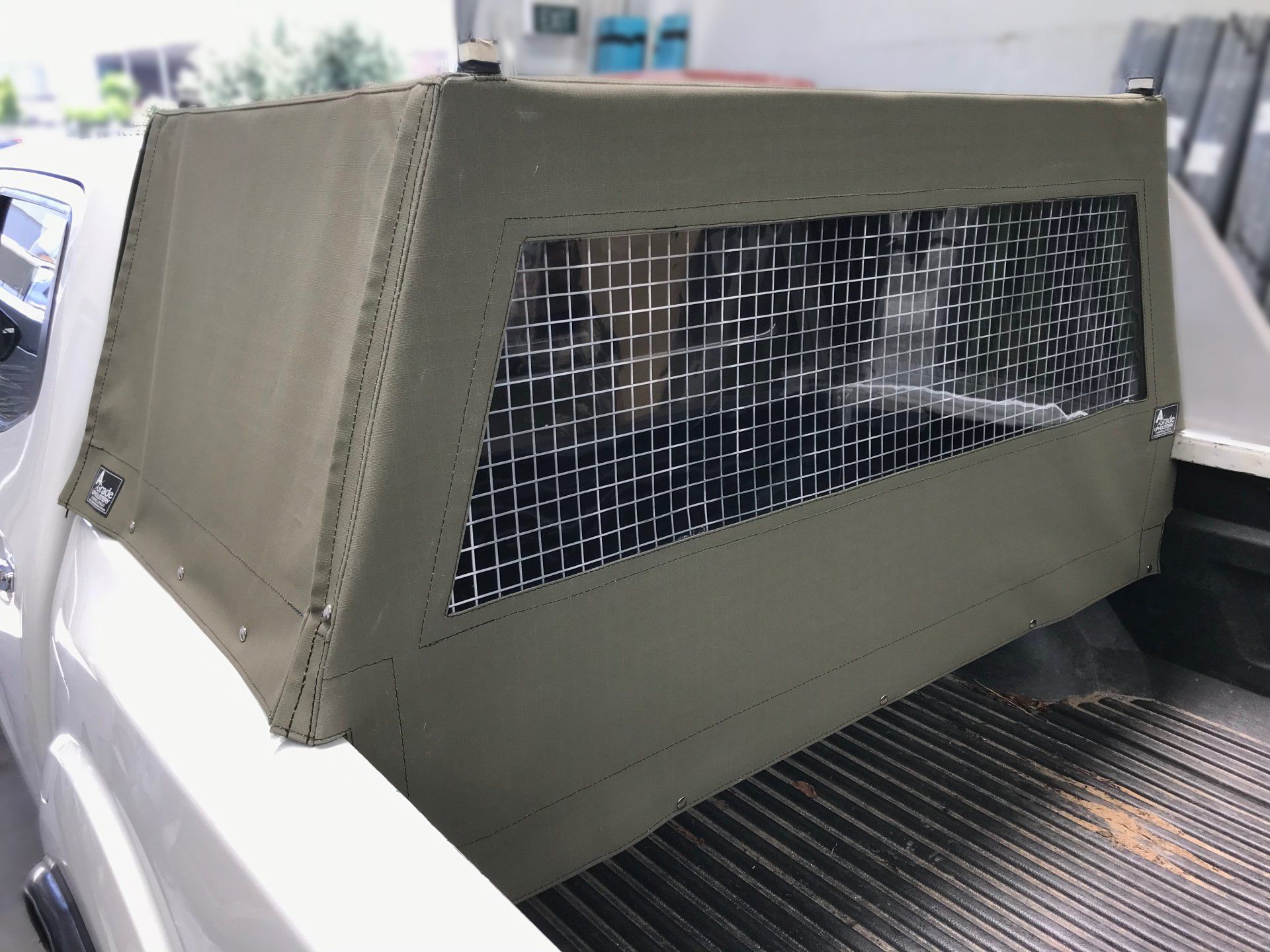 Dog box with khaki canvas cover and clear windows