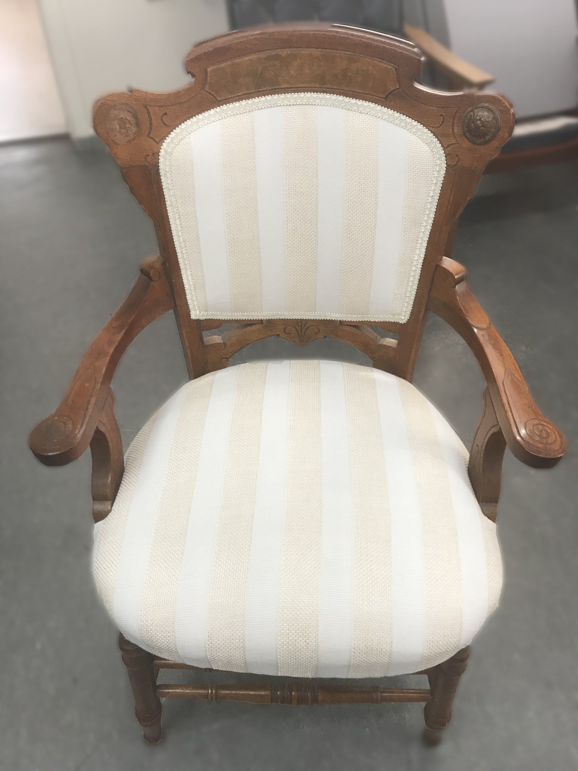 Fabric covered antique dining chair with arm rests