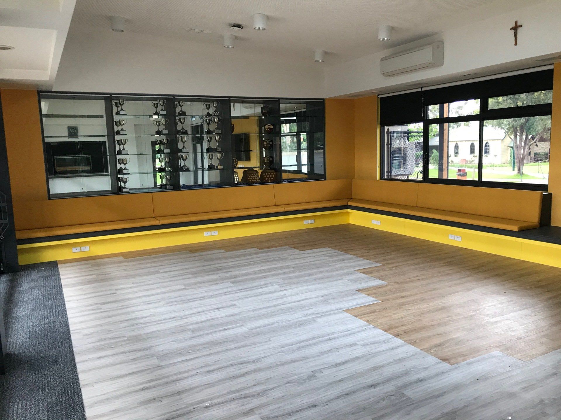 Loyola College activities room burnt yellow commercial vinyl wall seating