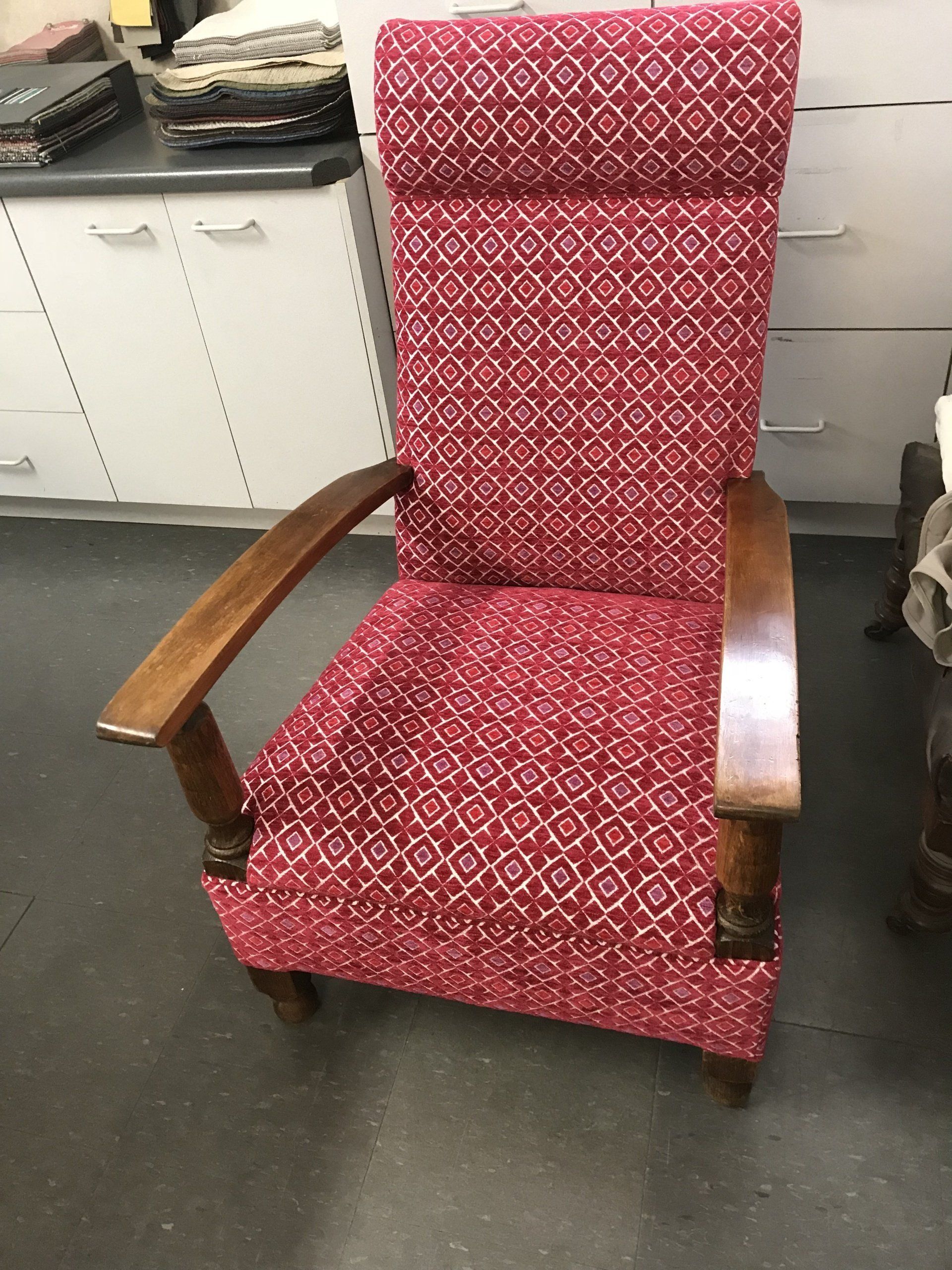 Single antique lounge chair with red geometric fabric