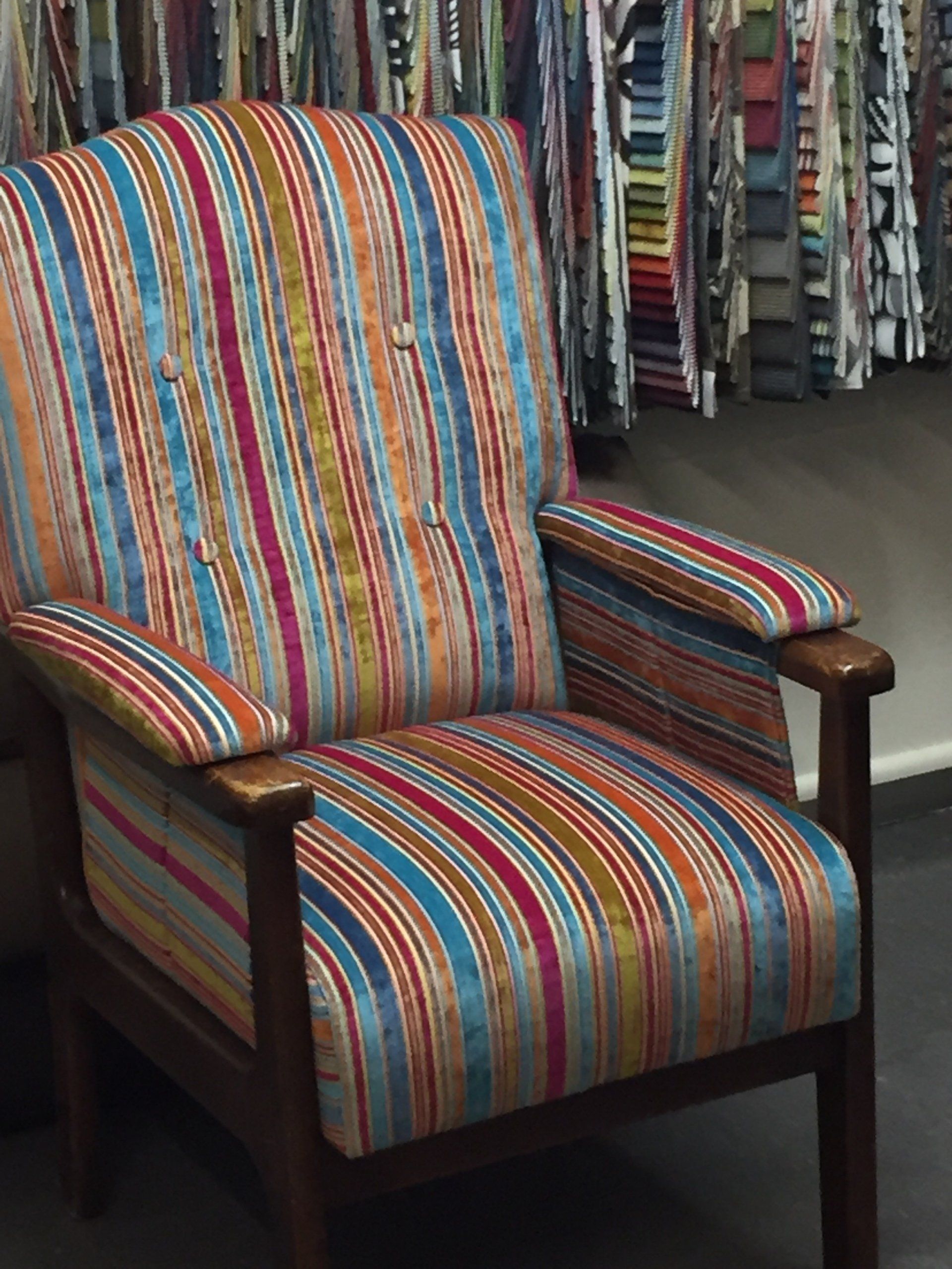 Single lounge arm chair with rainbow striped velvet