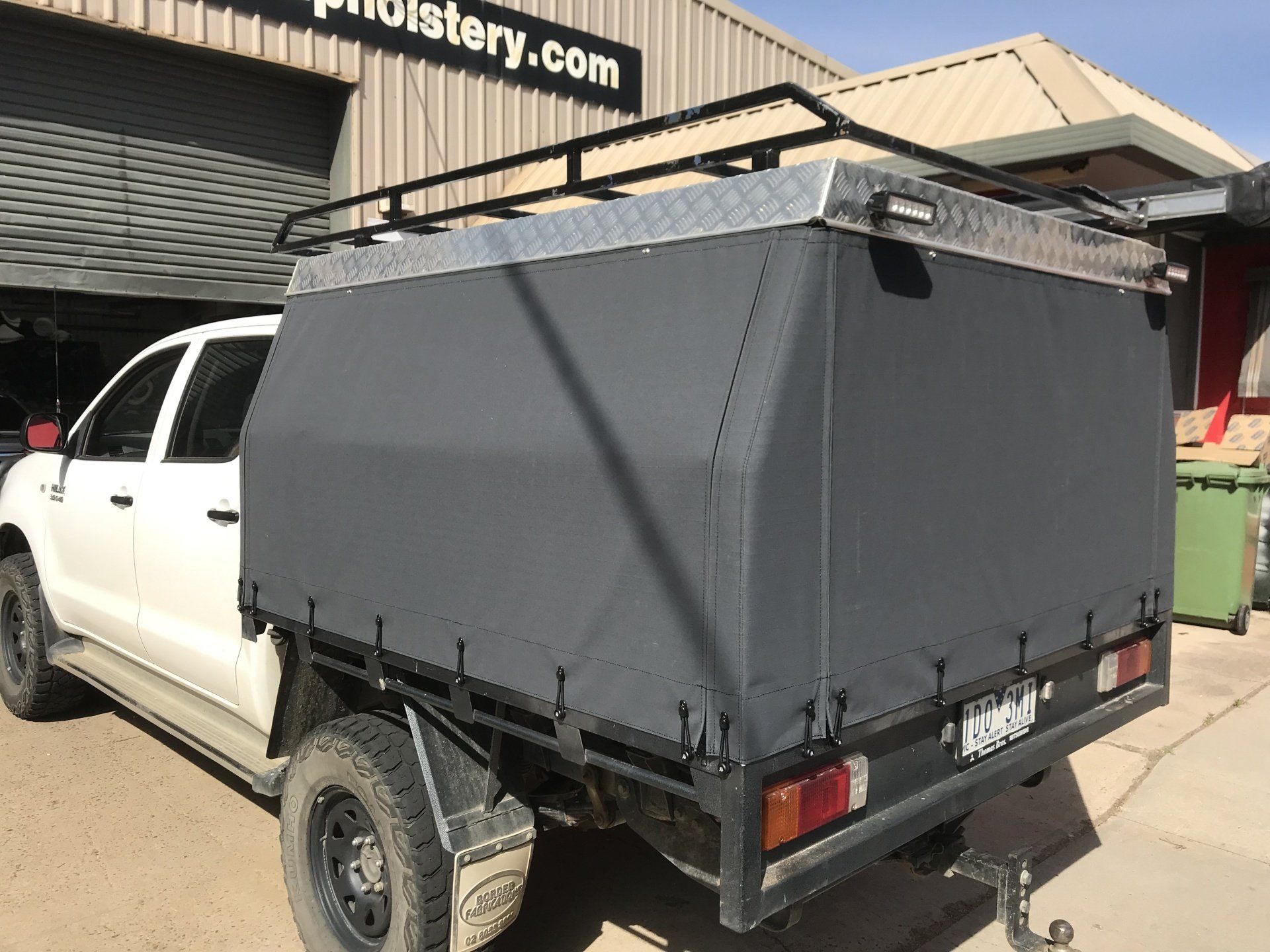 Ute canopy with checker plate roof and canvas sides