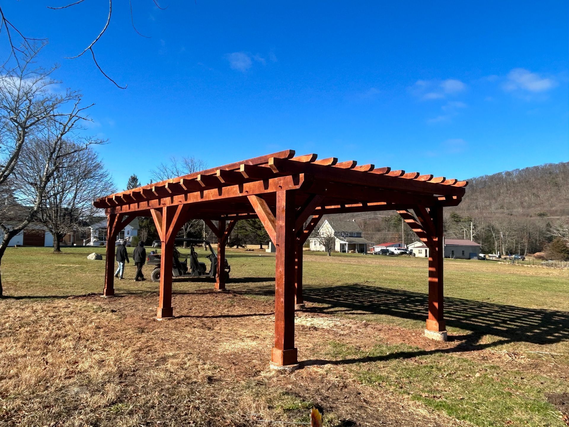 A large, brown wooden pergola by Central Timber Frame Supply serving PA, WV, VA, NY, NJ  