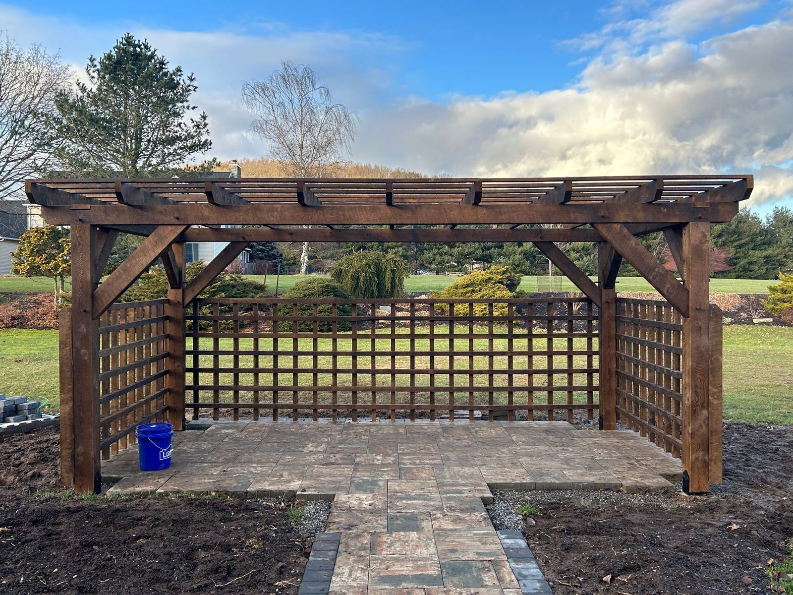 A wooden pergola by Central Timber Frame Supply serving PA, WV, VA, NY, NJ with lattice walls
