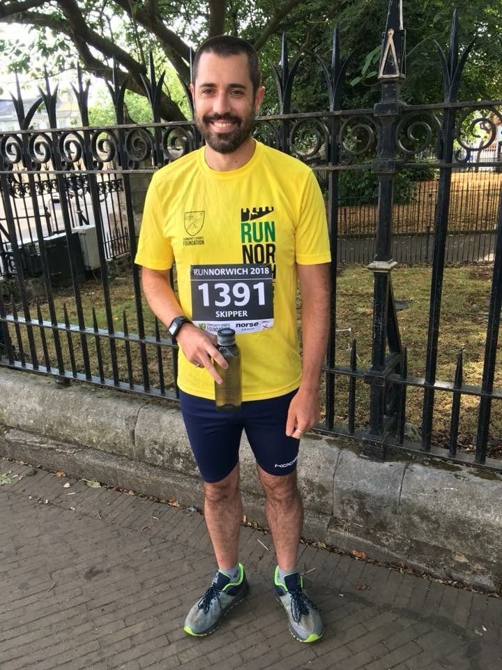Full length image of Dan Skipper in running gear, wearing  race number. 