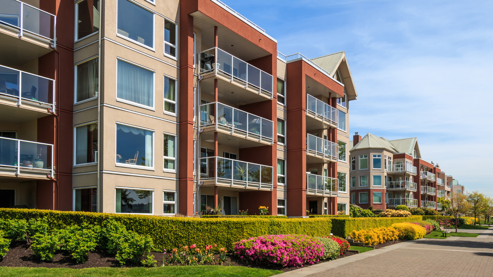A row of apartment buildings with balconies in a residential area.