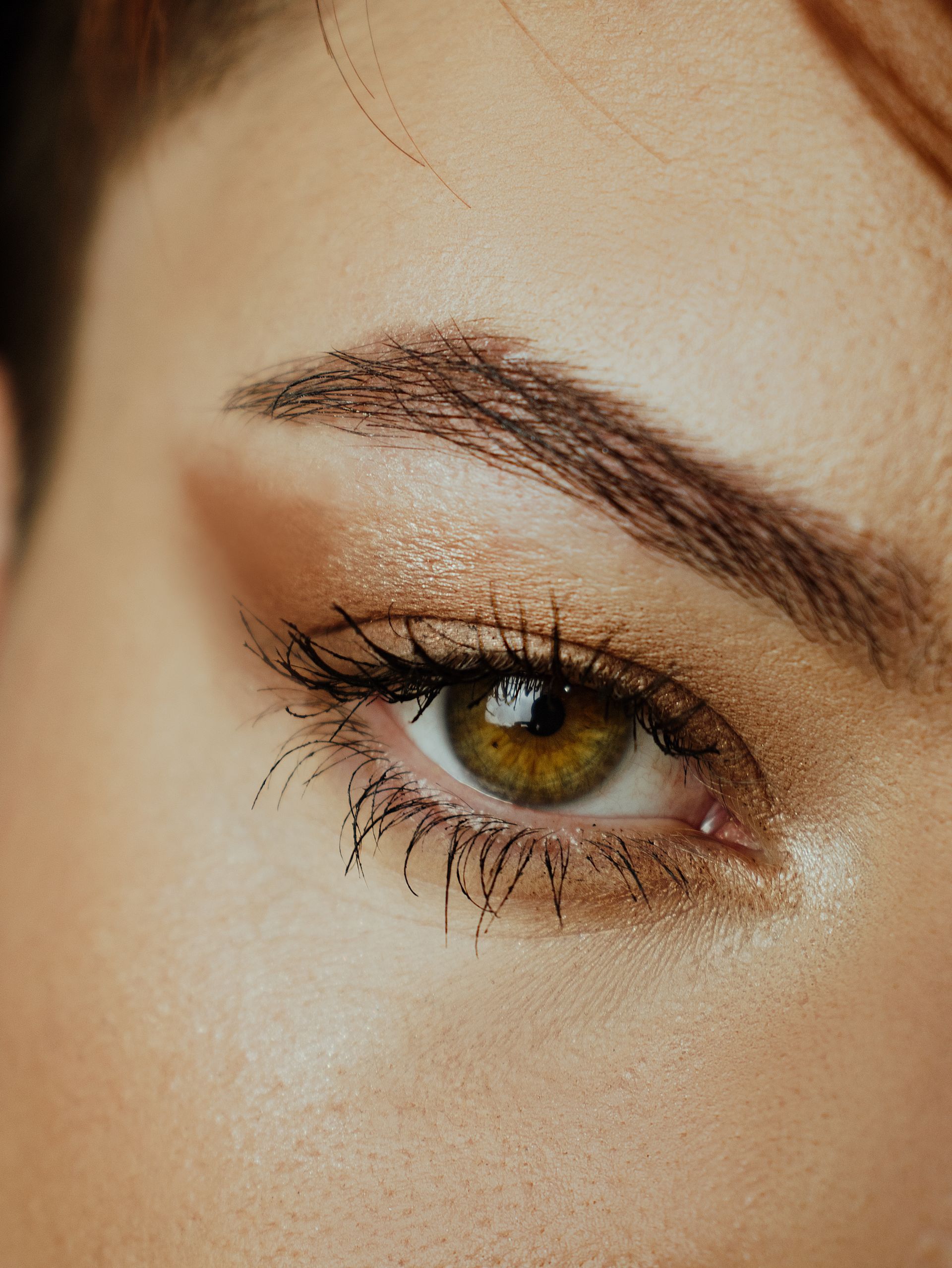 A close up of a woman 's eye with makeup on.