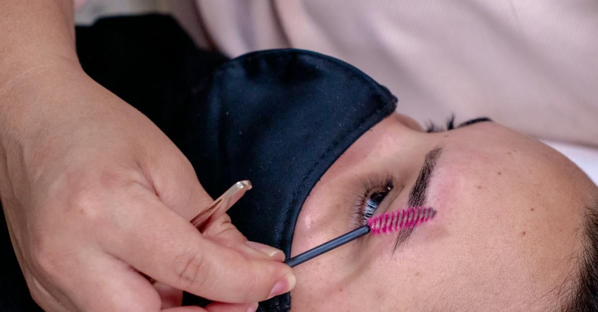 A woman is getting her eyelashes done at a beauty salon.