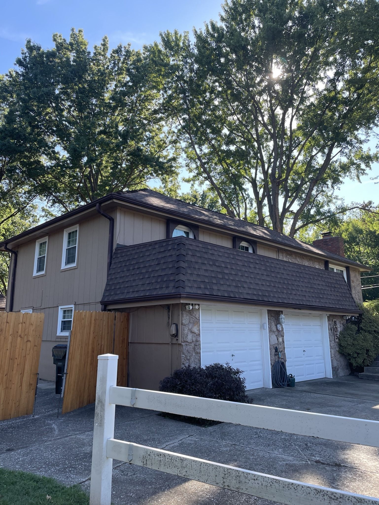 Close-up of brown and gray textured roof shingles with overlapping rectangular sections