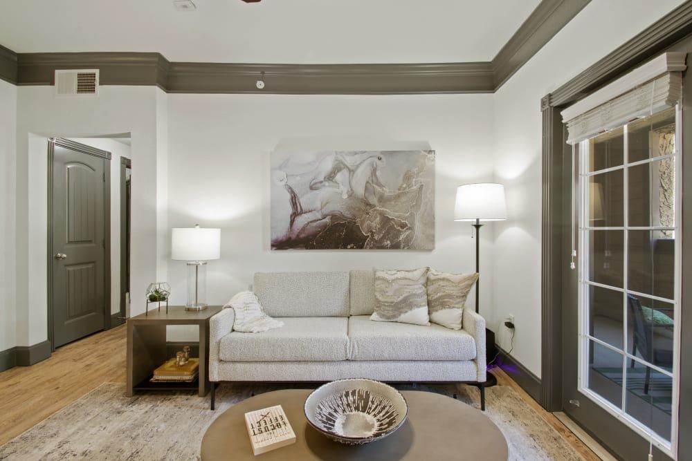 a living room with a couch and a coffee table at Marquis on Evans in San Antonio, TX.