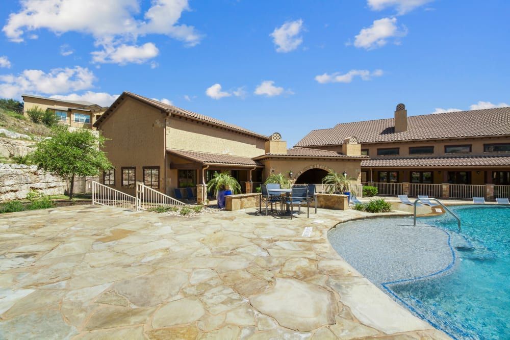 a large house with a swimming pool in front of it at Marquis on Evans in San Antonio, TX.