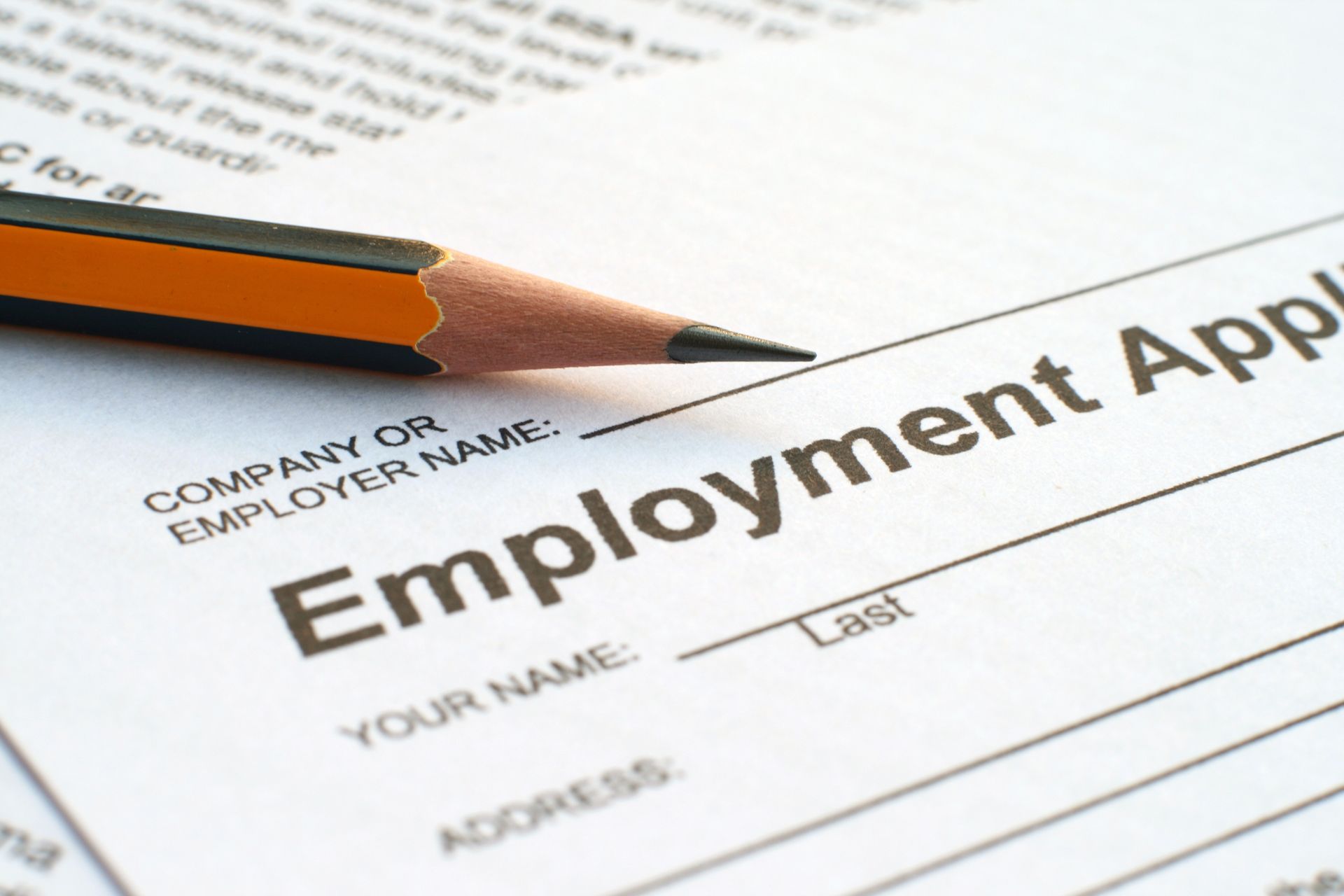 A pencil is laying on top of an employment application