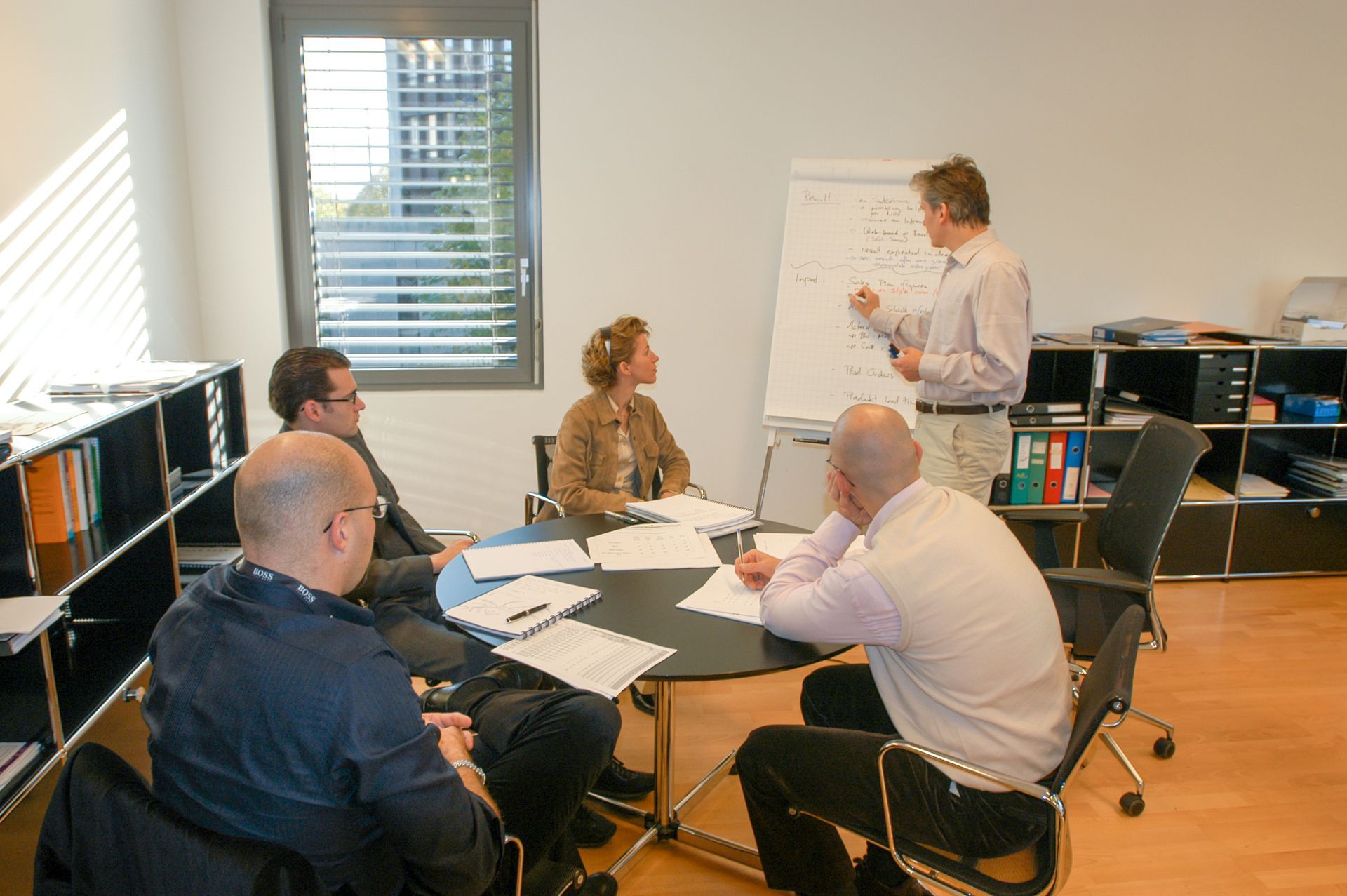 A man is giving a presentation to a group of people