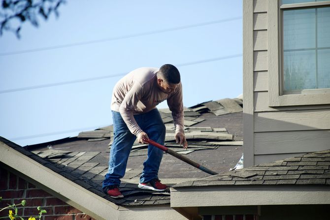 An image of roofer replacing and repairing an asphalt single residential roof in Ocoee FL