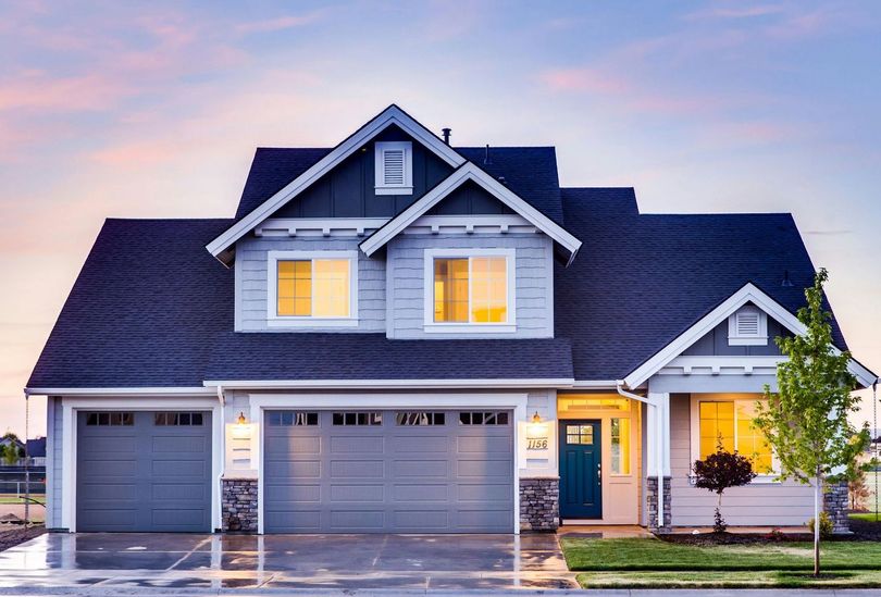 A house with a blue garage door and a blue door