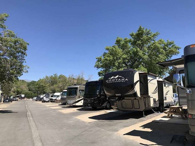 A row of recreational vehicles parked on the side of a road.