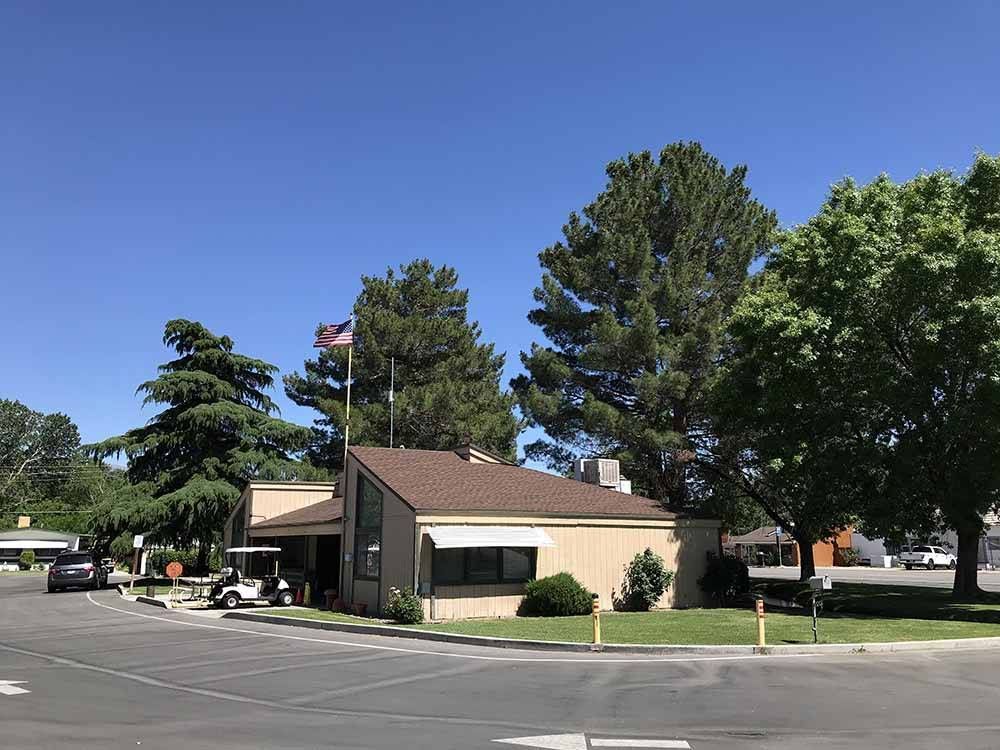 A small house with a golf cart parked in front of it.