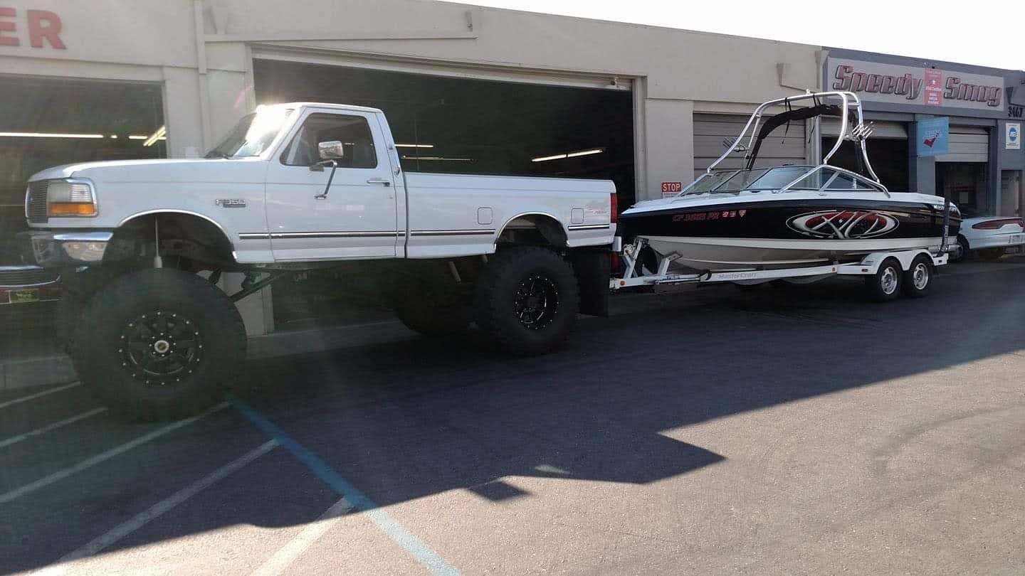 A Boat Trailer Hitched To A White Pickup — Santa Clara, CA — Eyers Hitch Center Inc.