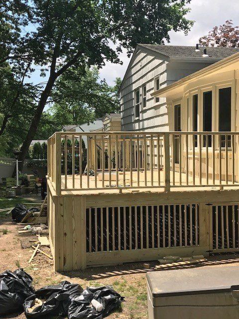 A house with a wooden deck in front of it