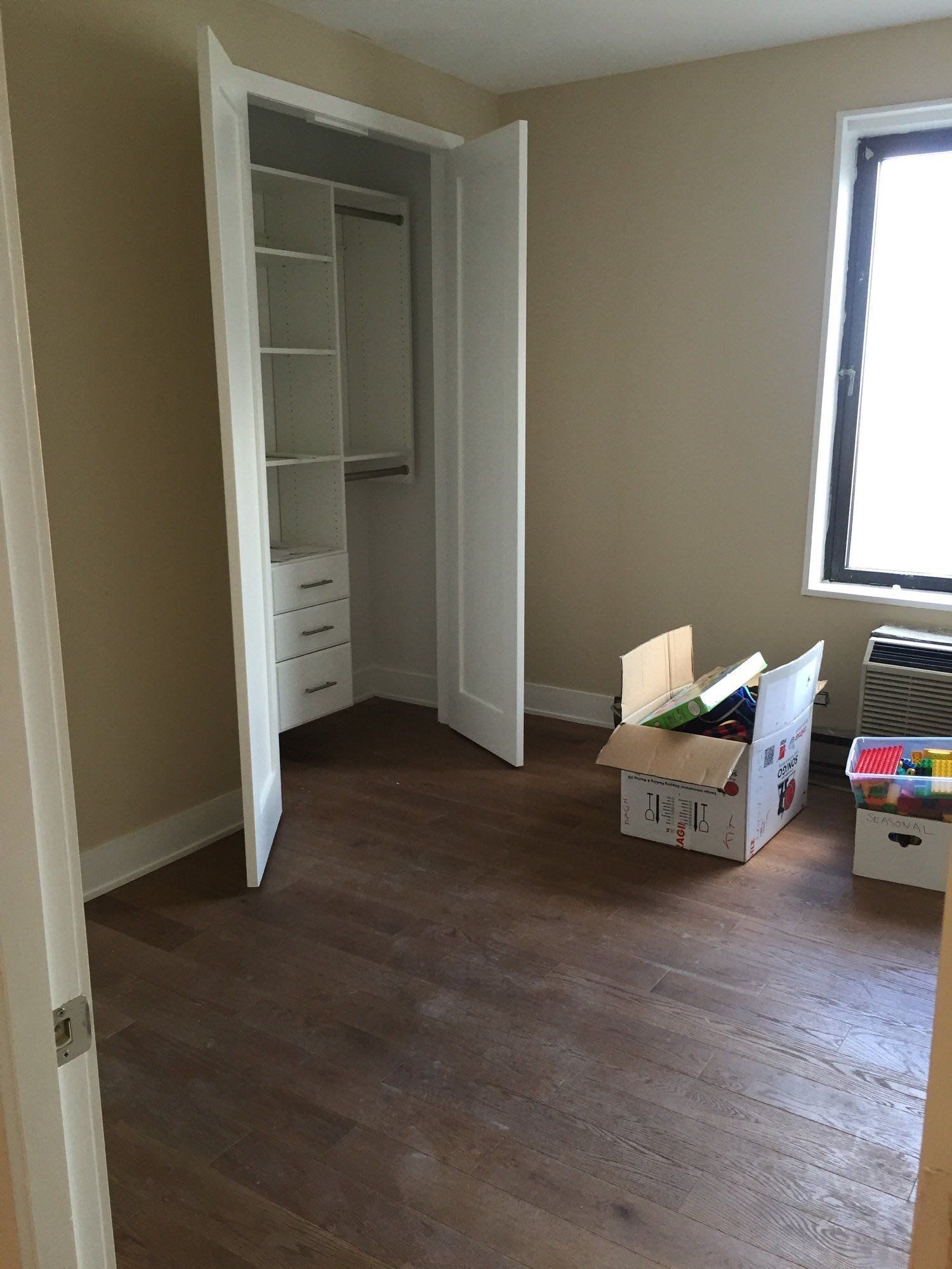 An empty room with a cardboard box in the middle of it.