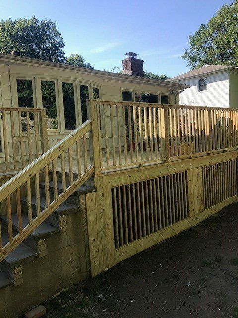 A wooden deck with stairs leading up to it