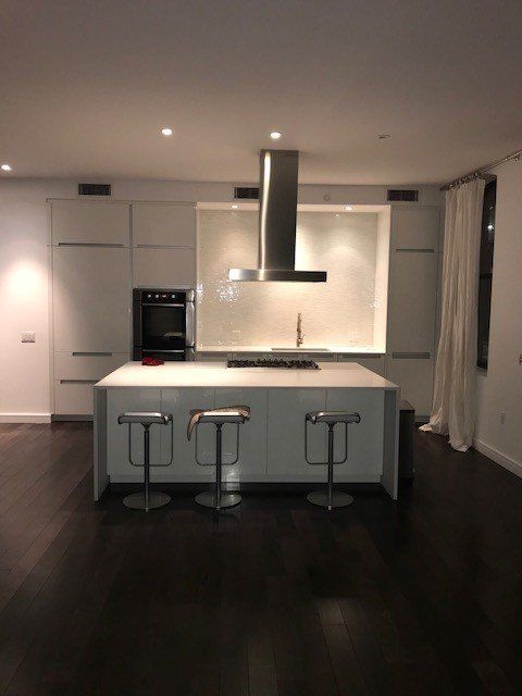 A kitchen with a large island and stools
