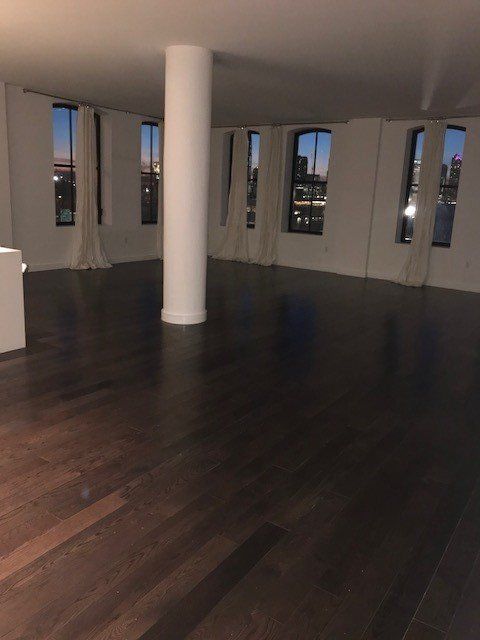 A large empty room with a pillar in the middle