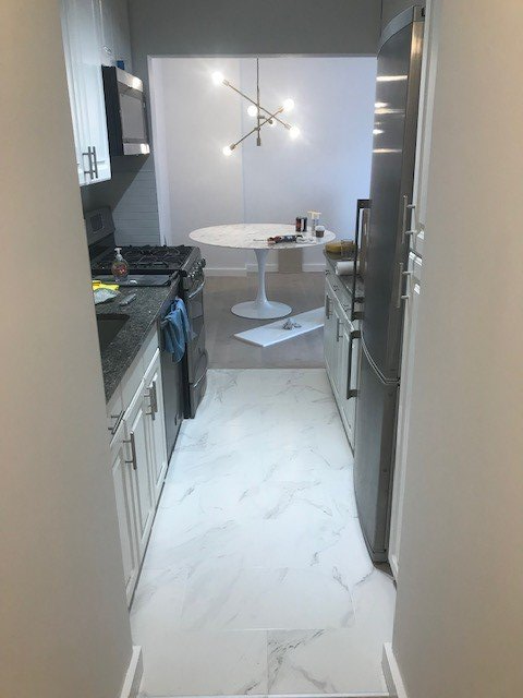 A kitchen with a table in the middle of it