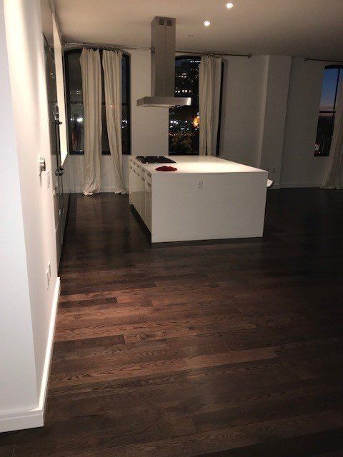 An empty kitchen with a large island in the middle