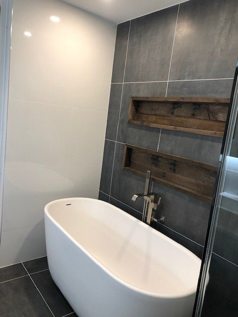 A bathroom with a bathtub and a shower.