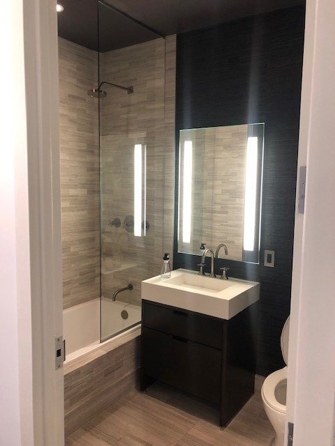 A bathroom with a sink a toilet and a bathtub