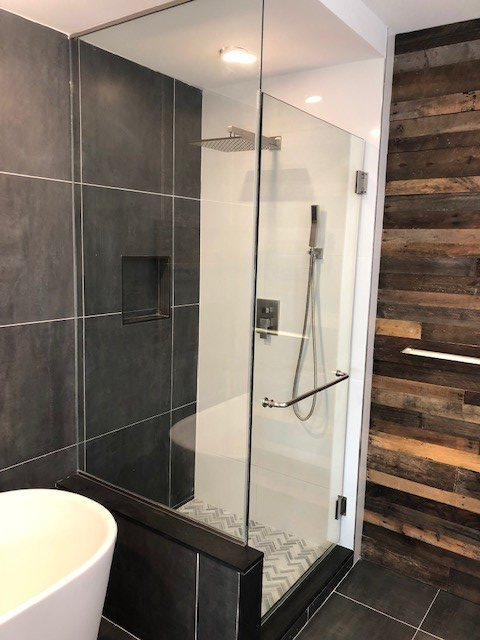 A bathroom with a walk in shower and a bathtub.