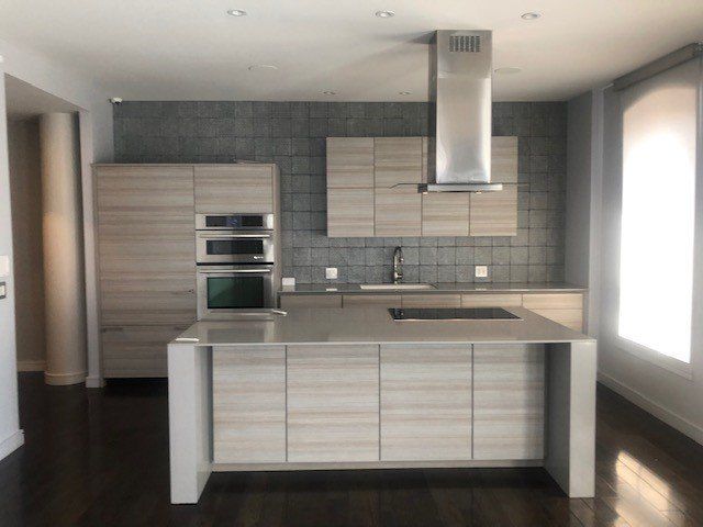 A kitchen with stainless steel appliances and wooden cabinets