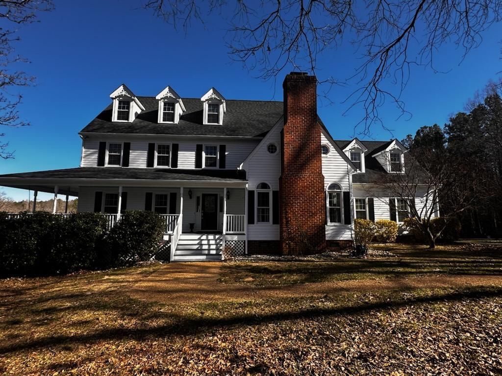 A large white house with a brick chimney