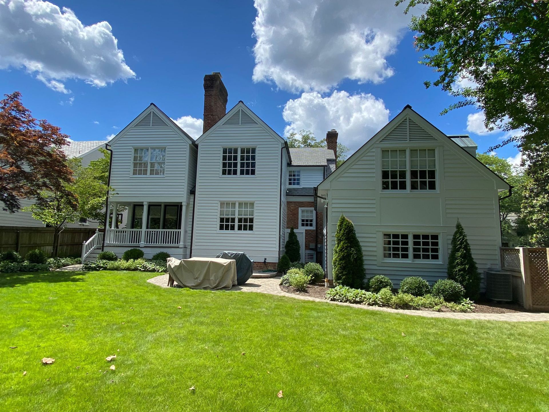 A large white house with a large lawn in front of it