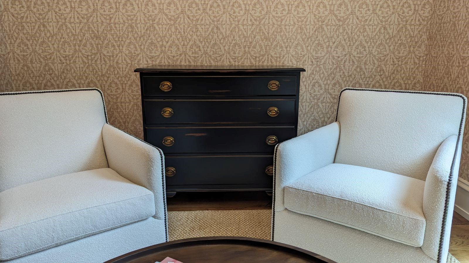 Two chairs are sitting next to a coffee table in a living room.