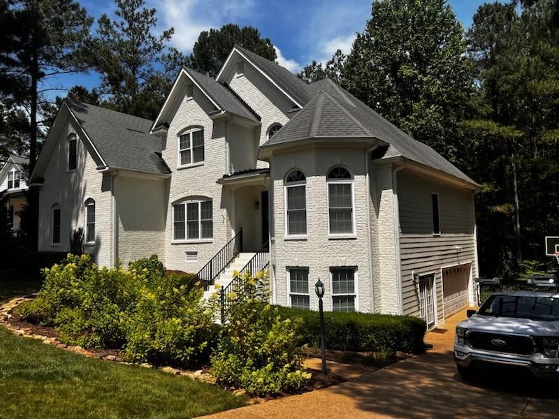 A large white house with a car parked in front of it