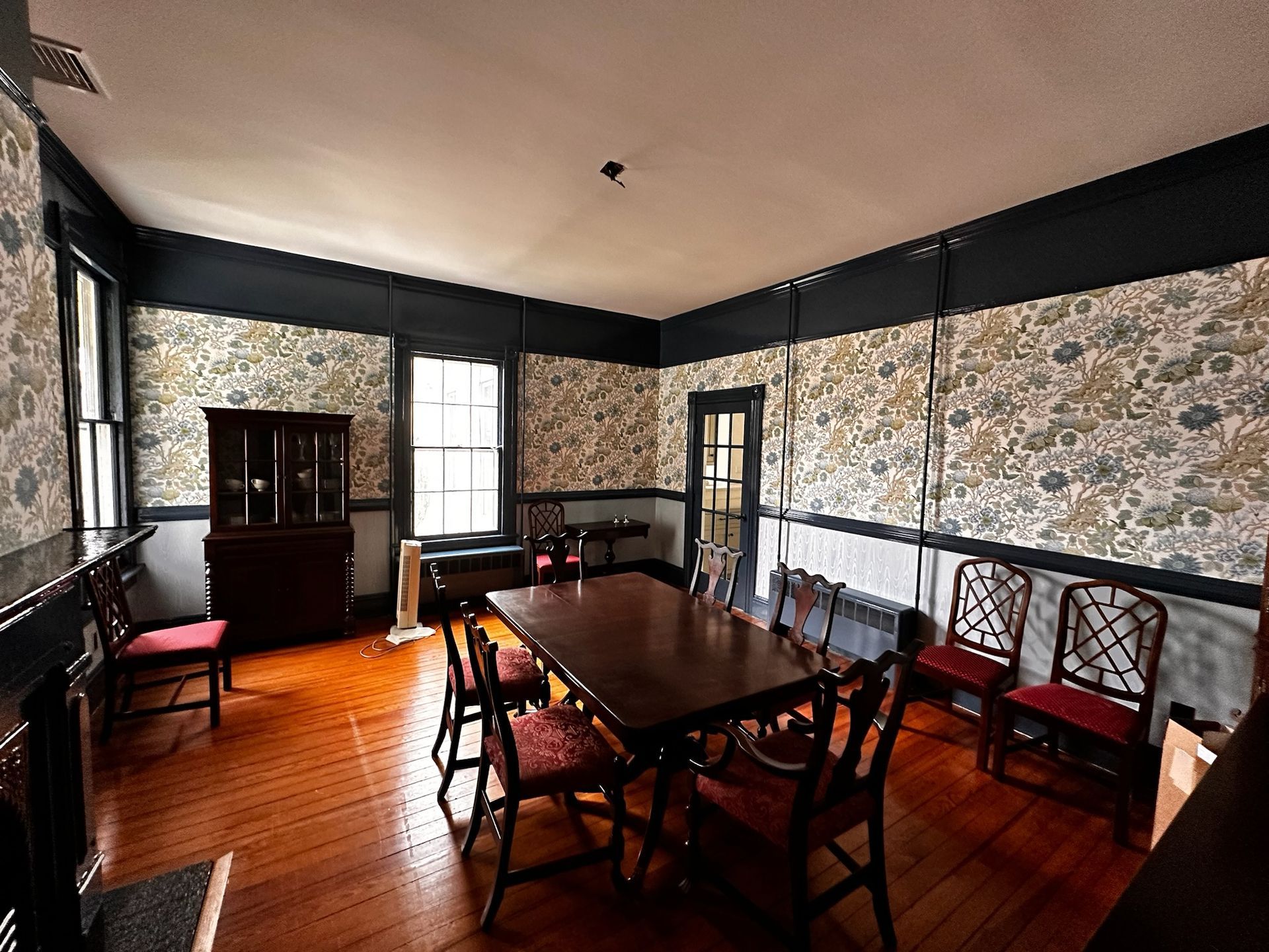 A dining room with a table and chairs in it