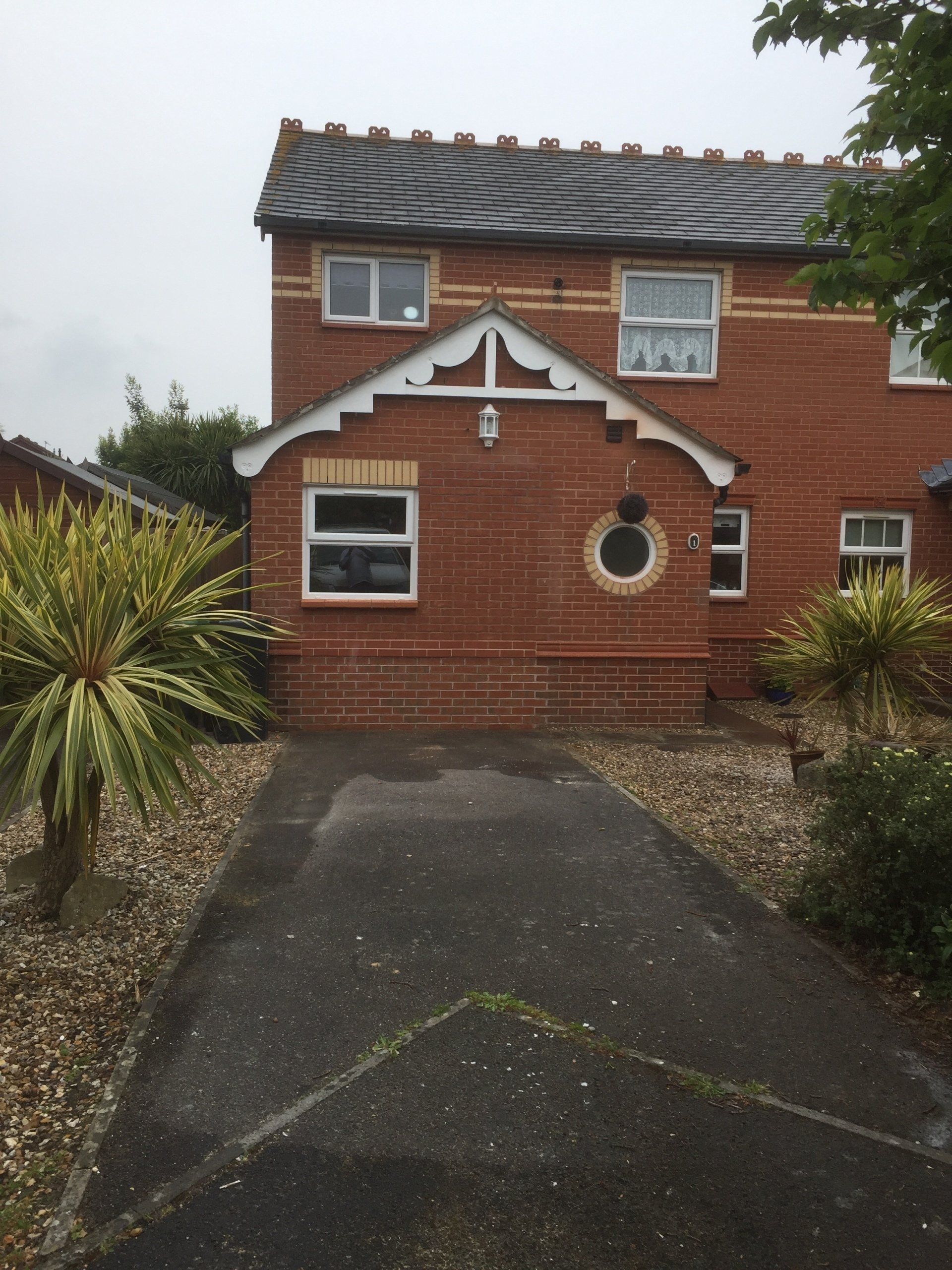 finished garage conversion with pretty round window