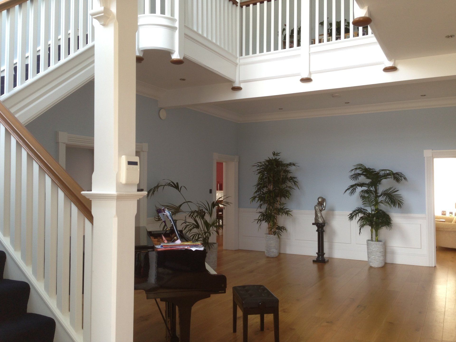 grand hallway with staircase and piano