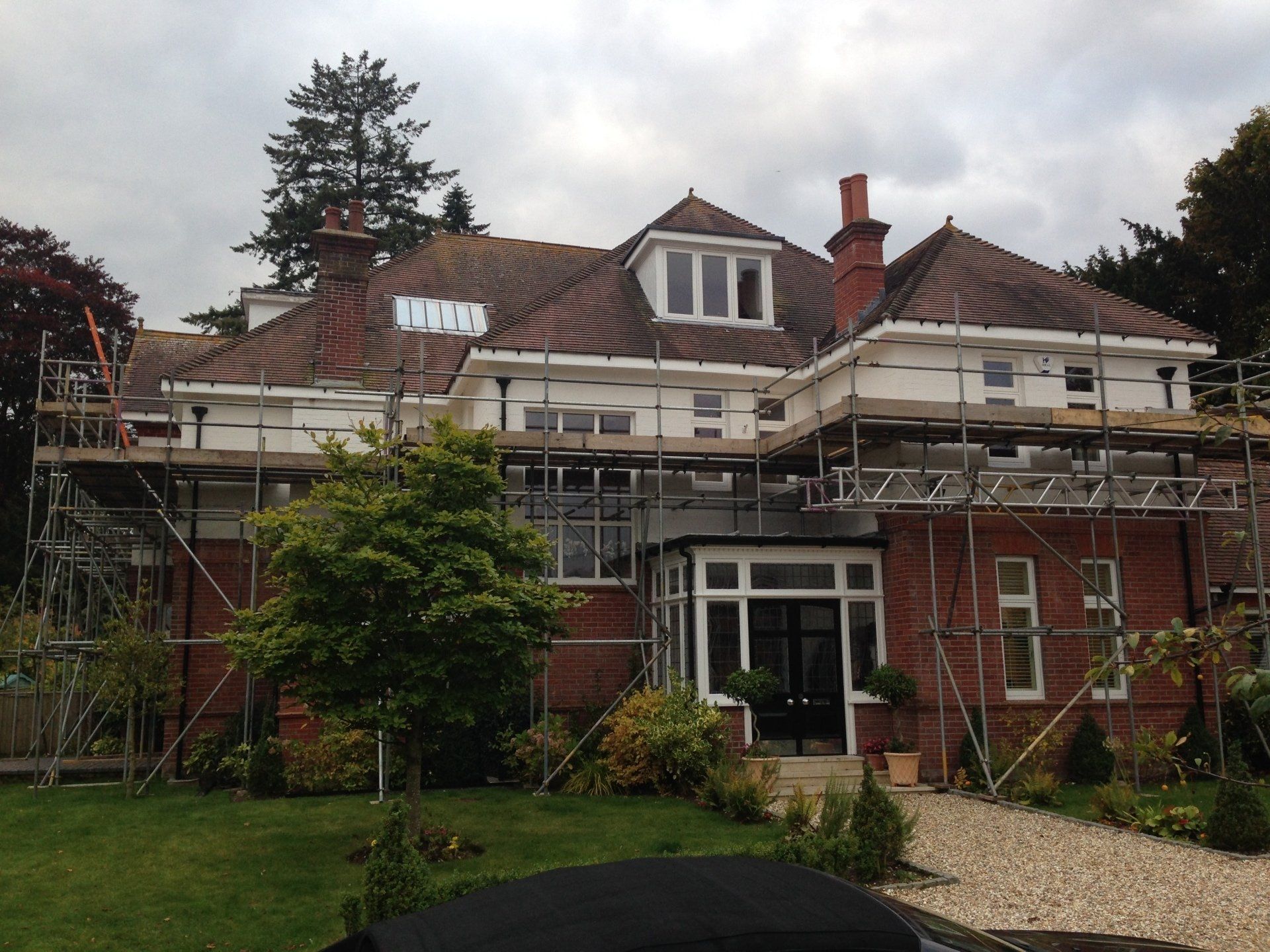 large home with scaffolding up
